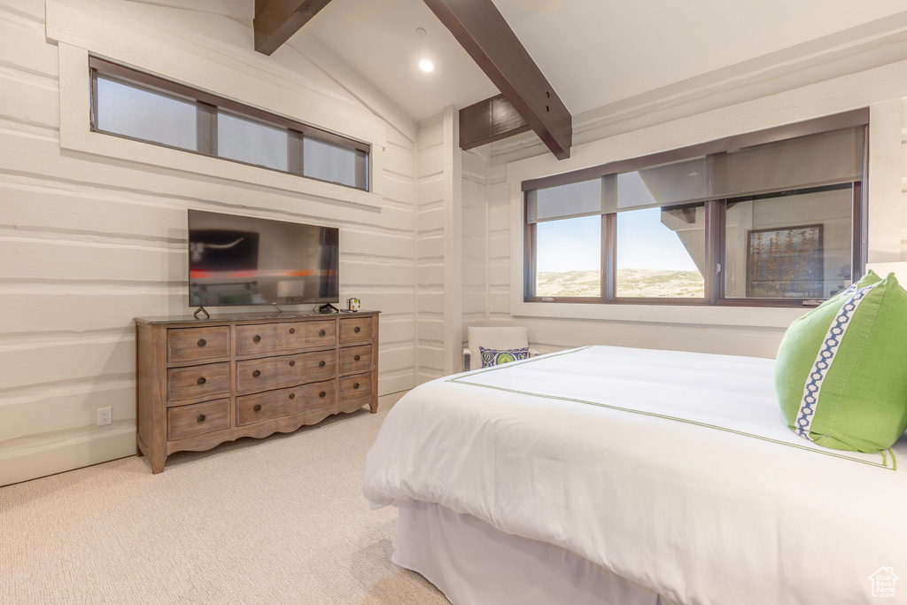 Bedroom with light carpet and lofted ceiling with beams