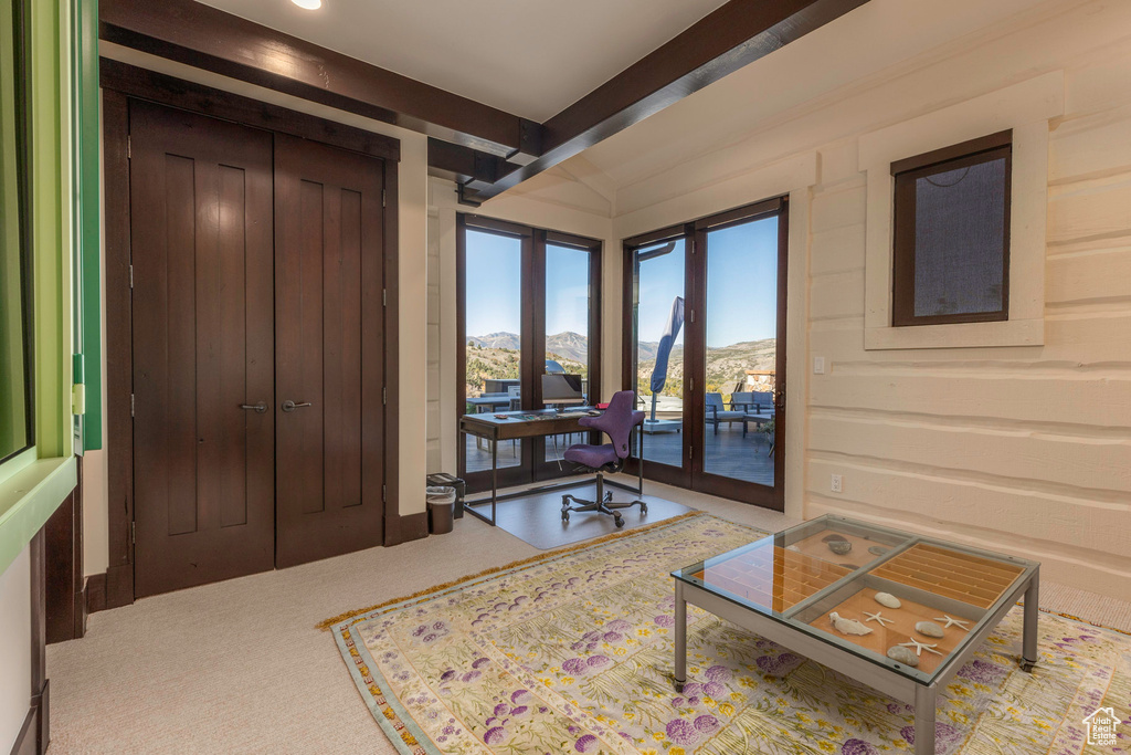 Interior space featuring a mountain view and beam ceiling