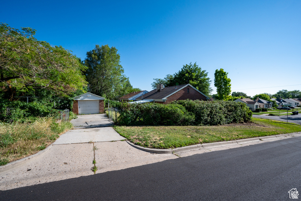 View of front of property featuring an outbuilding and a garage