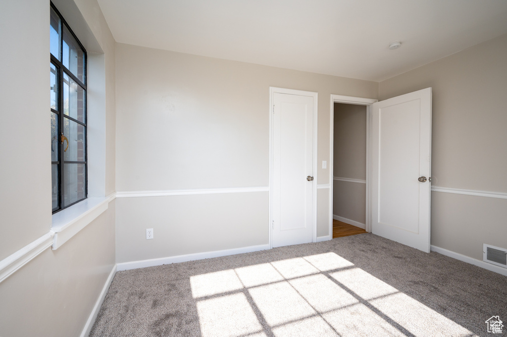 Spare room featuring carpet flooring
