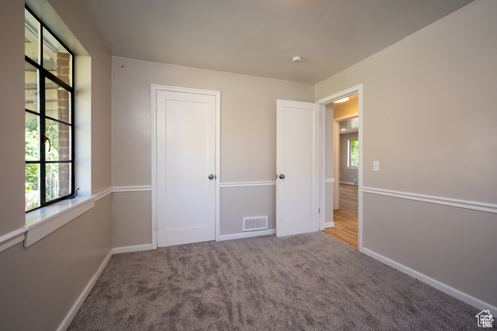 Unfurnished bedroom featuring light carpet