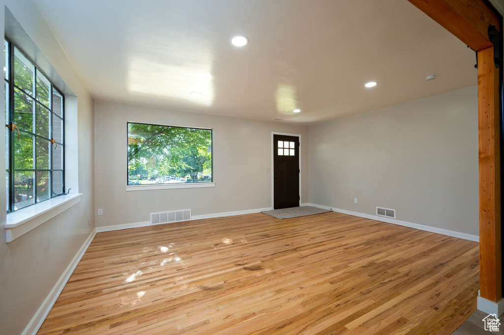 Spare room featuring plenty of natural light and light wood-type flooring