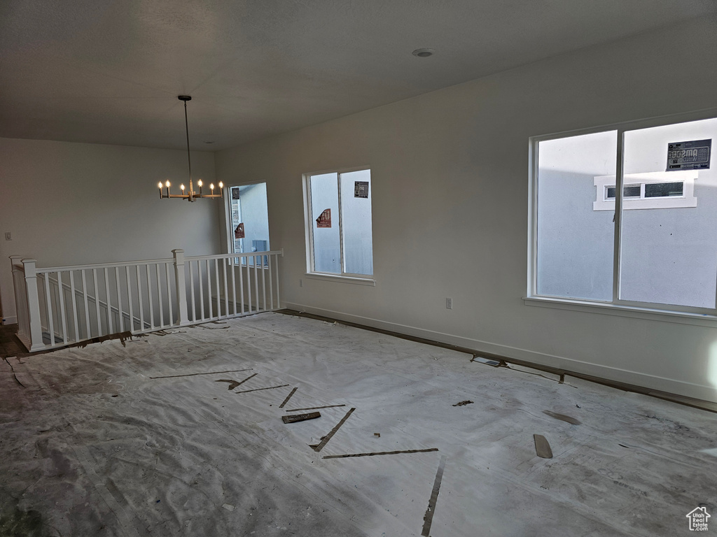 Unfurnished room with an inviting chandelier