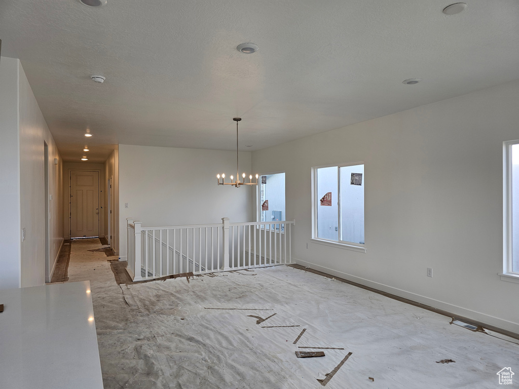 Spare room with a notable chandelier