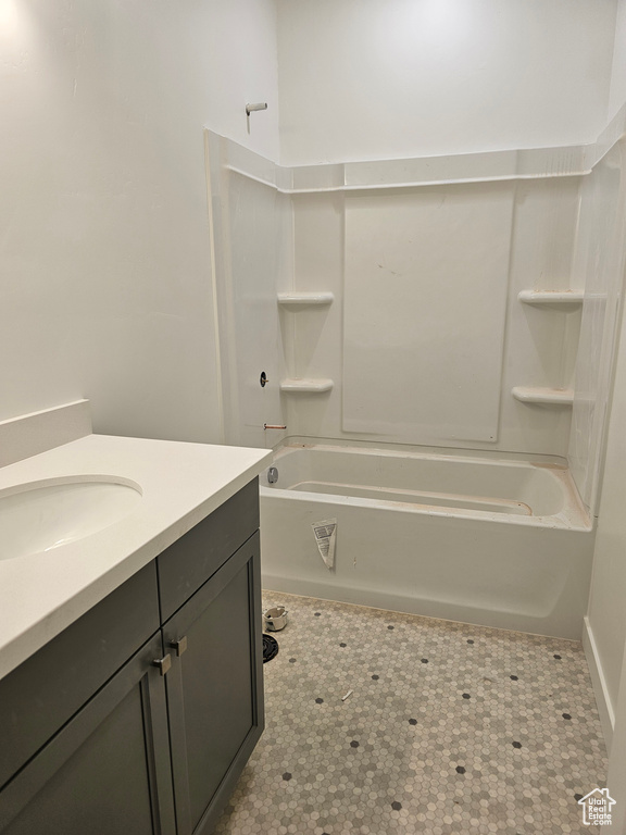 Bathroom featuring vanity and  shower combination