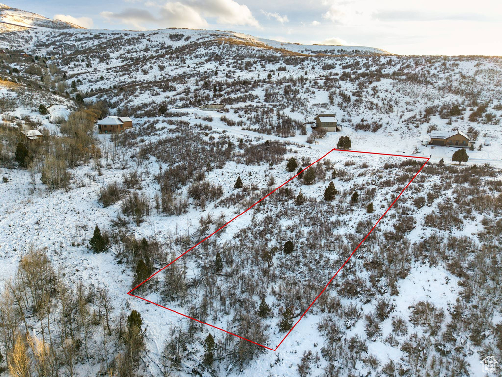 Snowy aerial view featuring a mountain view