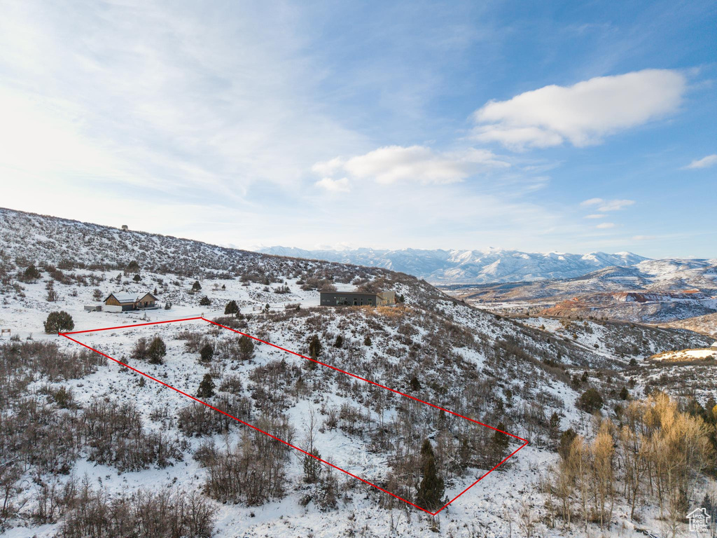 Snowy aerial view featuring a mountain view