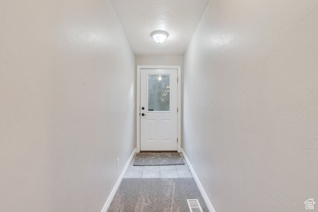 Doorway to outside with light tile patterned floors