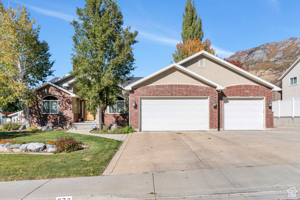 View of front facade featuring a mountain view and a garage