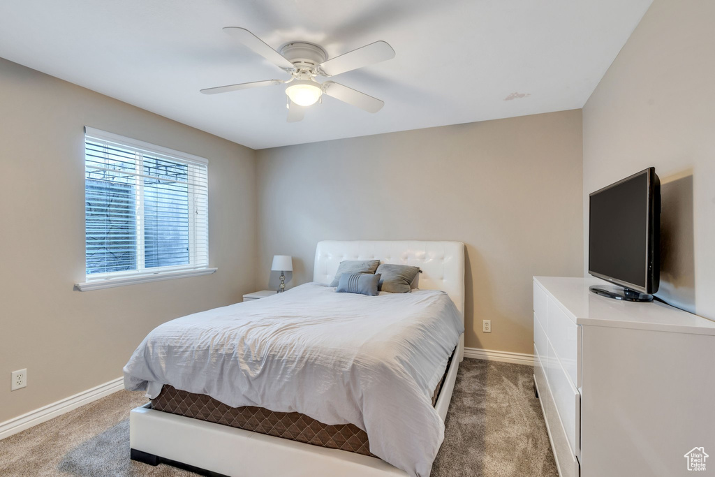 Carpeted bedroom with ceiling fan