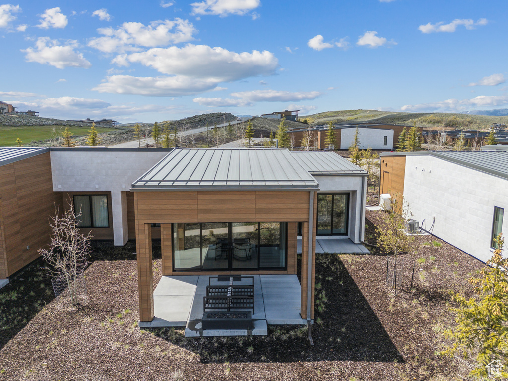 Back of house featuring a standing seam roof, metal roof, and a mountain view