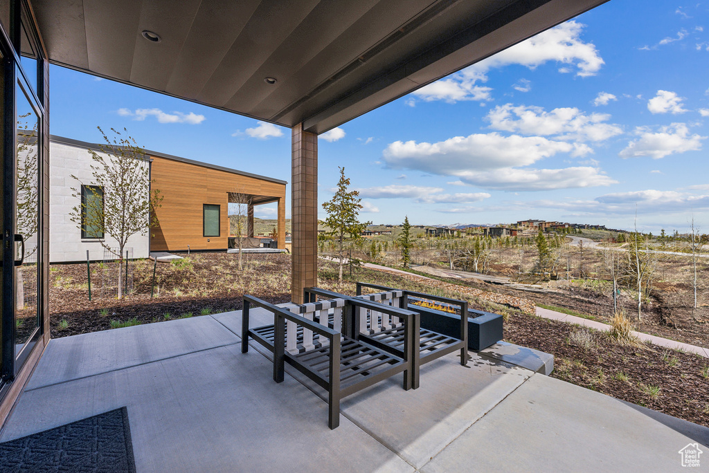 View of patio with an outdoor fire pit