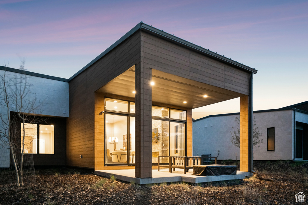 View of back of house at dusk