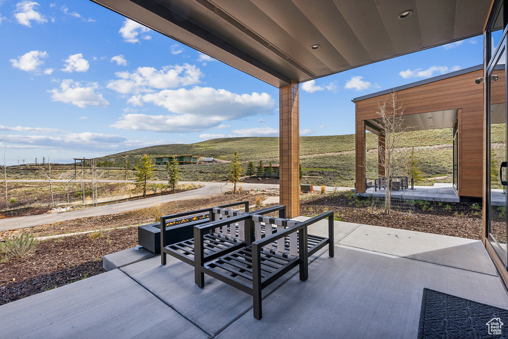 View of patio / terrace with a view of countryside and a mountain view