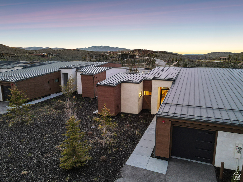 View of front of house featuring a standing seam roof, metal roof, and a mountain view