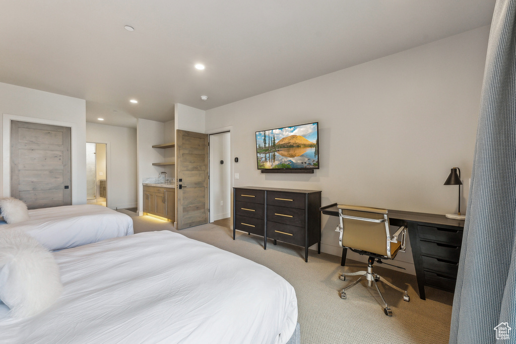 Bedroom featuring light carpet, recessed lighting, a desk, baseboards, and ensuite bath