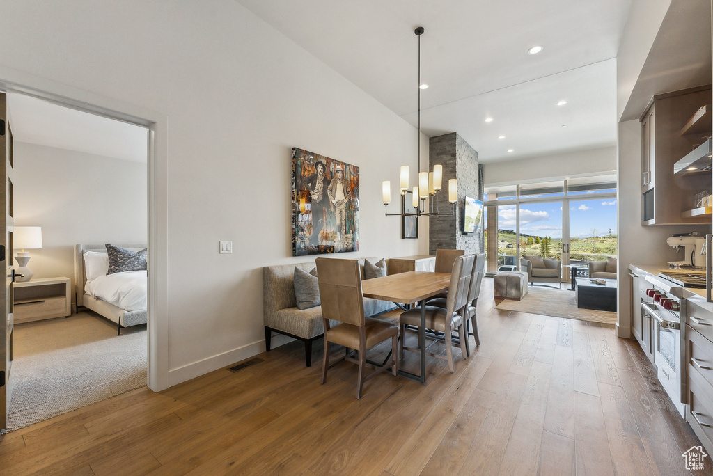 Dining area with wood-type flooring, recessed lighting, and baseboards