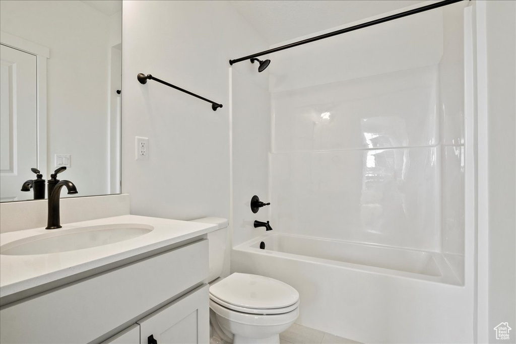 Full bathroom with bathtub / shower combination, vanity, and toilet