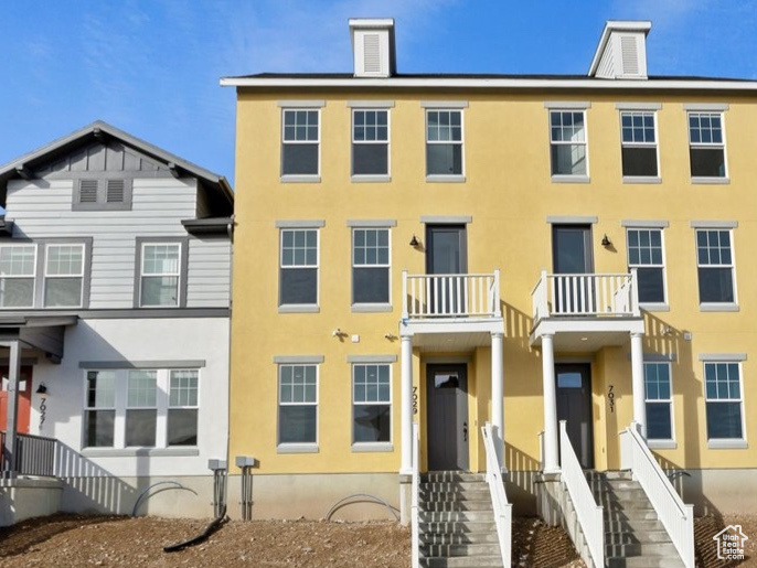 View of front of house featuring a balcony