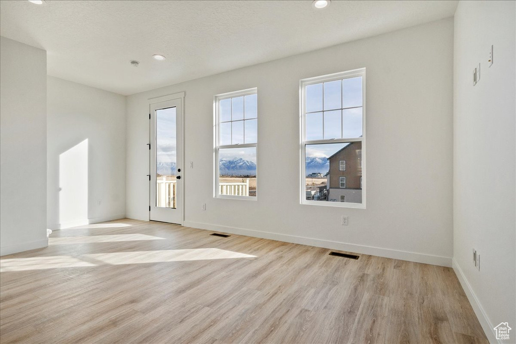 Empty room featuring light hardwood / wood-style flooring