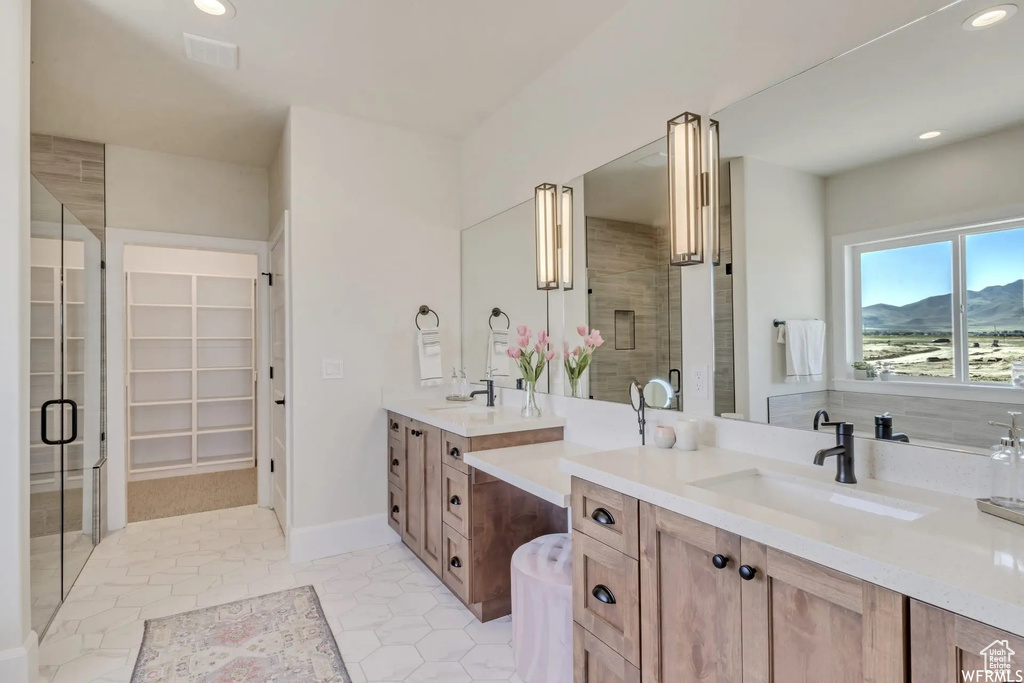 Bathroom with tile patterned flooring, a mountain view, walk in shower, and vanity