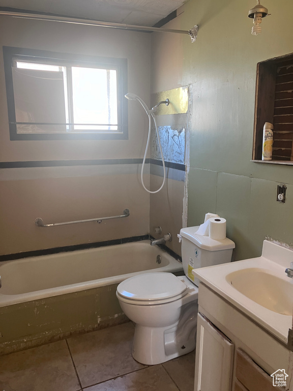 Full bathroom featuring toilet, tile patterned flooring, vanity, and bathing tub / shower combination