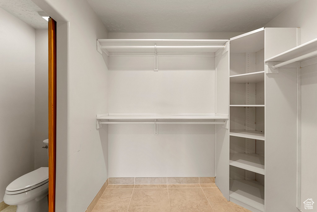 Walk in closet featuring light tile patterned floors
