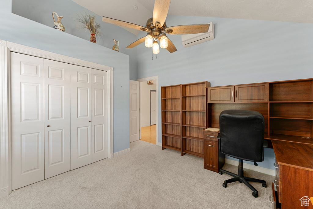 Office with a wall unit AC, light colored carpet, ceiling fan, a high ceiling, and baseboards
