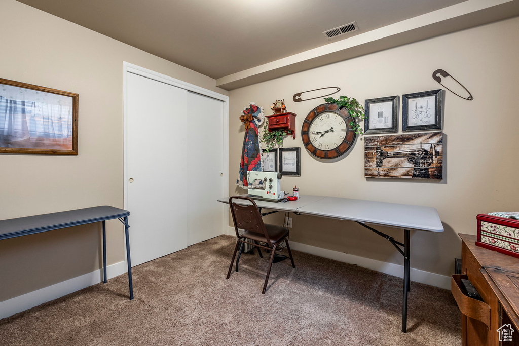 Carpeted office space featuring baseboards and visible vents
