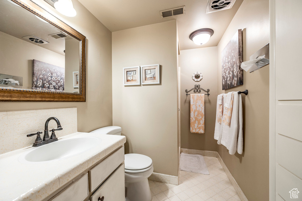 Bathroom featuring visible vents, tile patterned floors, and toilet