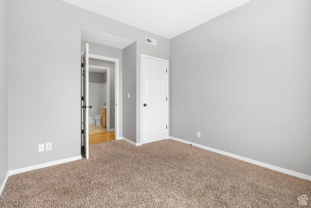 Unfurnished bedroom with carpet floors