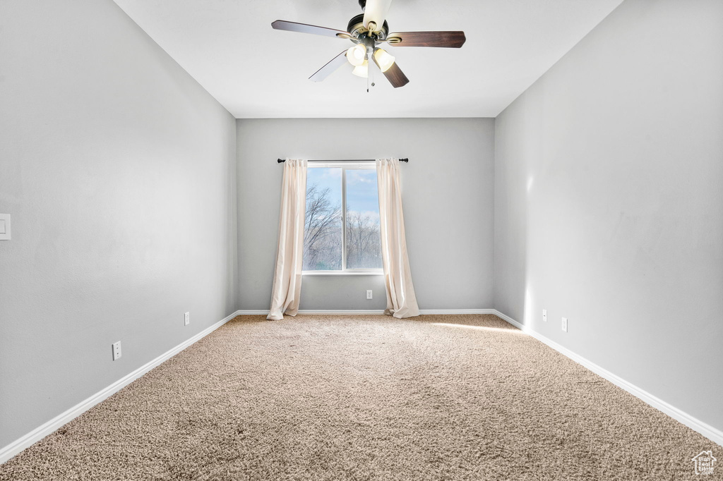 Unfurnished room with carpet floors and ceiling fan