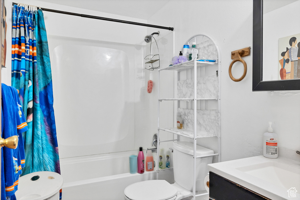 Full bathroom with shower / bath combination with curtain, toilet, and vanity