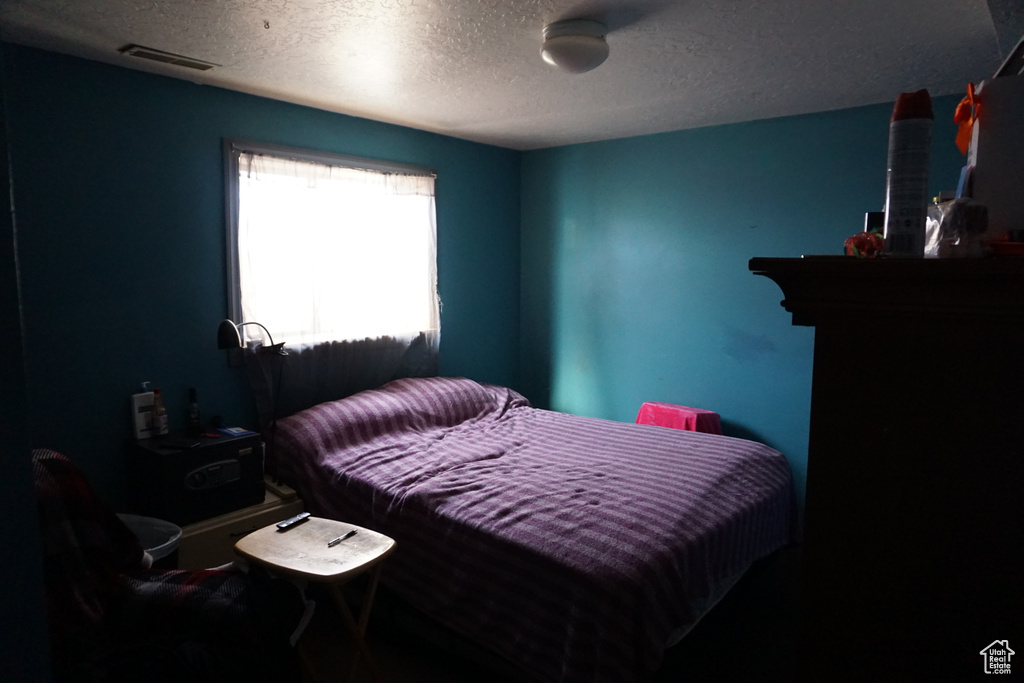 Bedroom featuring a textured ceiling and visible vents