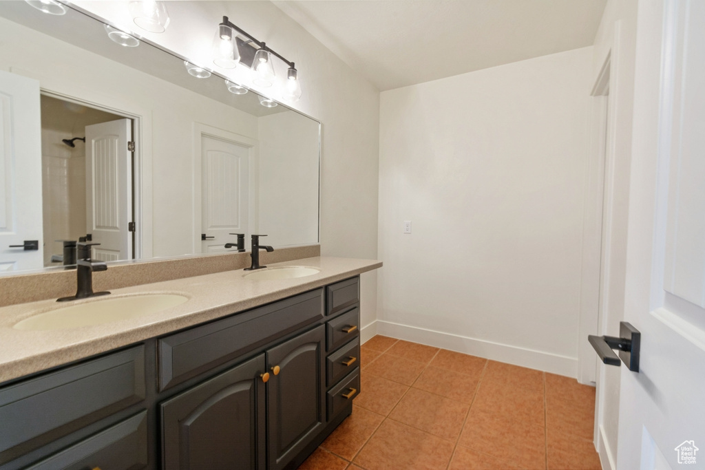 Bathroom with tile patterned floors and vanity