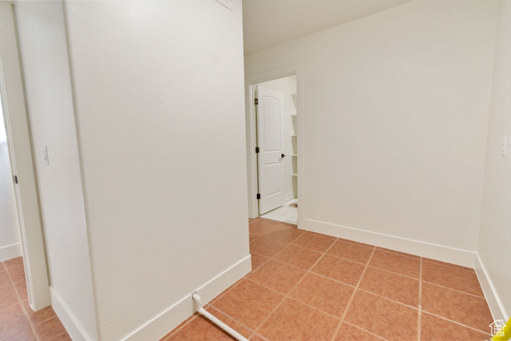 Hallway with tile patterned flooring