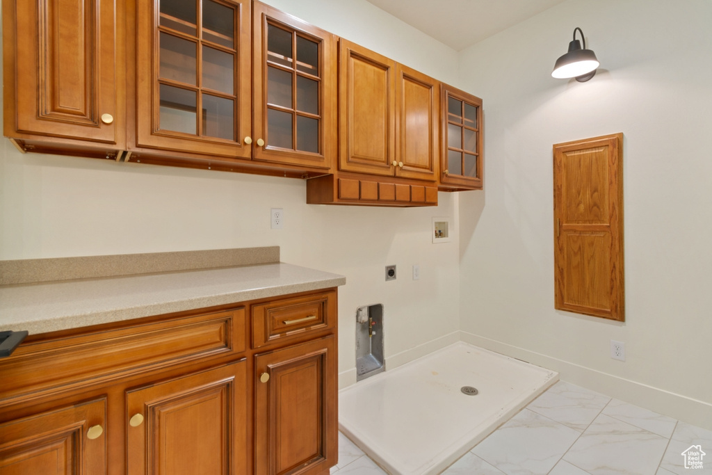 Interior space featuring cabinets, washer hookup, and hookup for an electric dryer