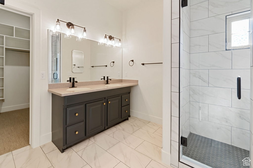 Bathroom with a shower with door and vanity