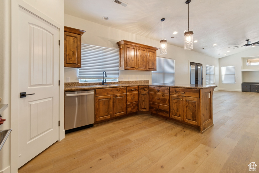 Kitchen with sink, stainless steel dishwasher, ceiling fan, decorative light fixtures, and kitchen peninsula