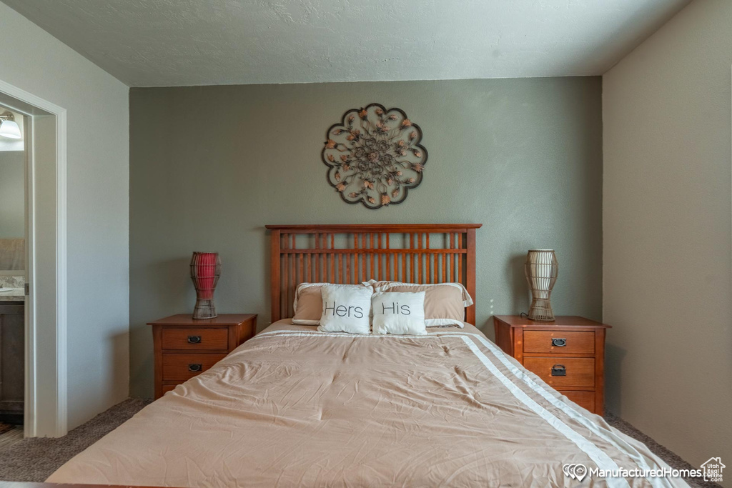 Bedroom featuring carpet and a textured ceiling