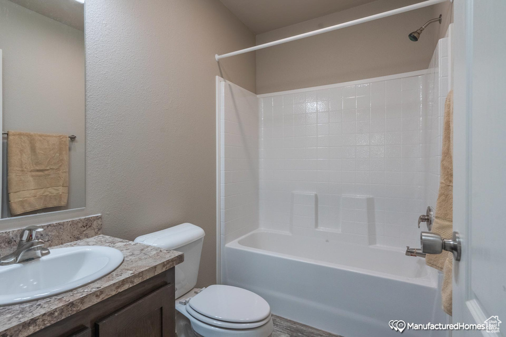 Full bathroom featuring washtub / shower combination, vanity, and toilet