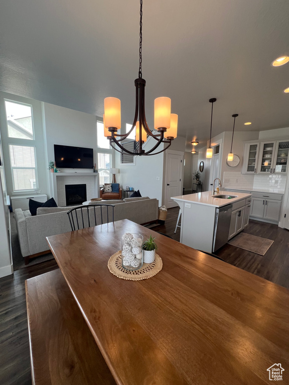 Dining area featuring dark hardwood / wood-style floors, an inviting chandelier, plenty of natural light, and sink