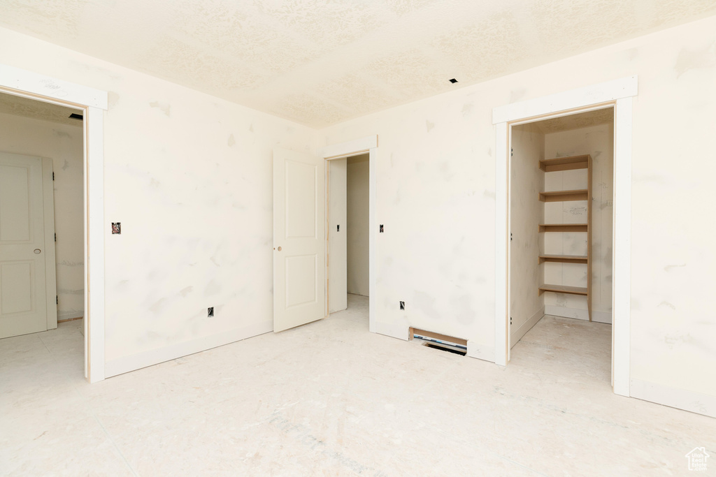 Spare room featuring visible vents and a textured ceiling