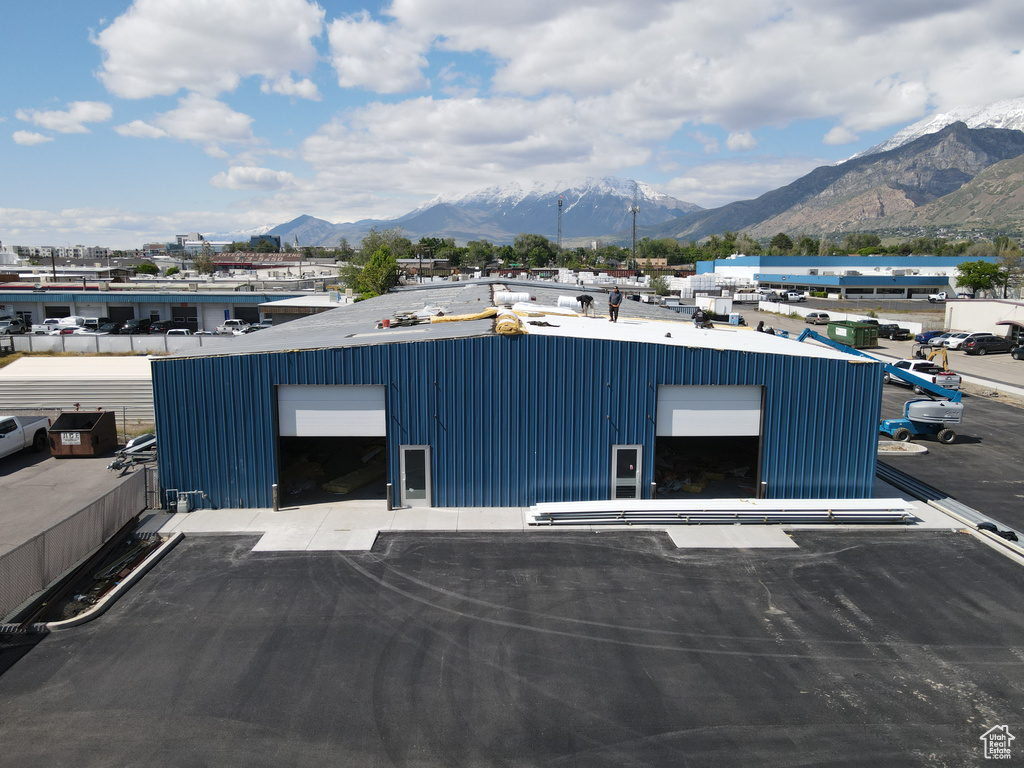 View of building exterior with a mountain view and a garage