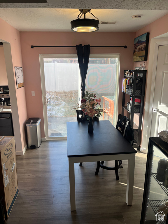 Dining space featuring a wealth of natural light and hardwood / wood-style flooring