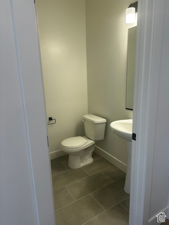 Bathroom with baseboards and tile patterned flooring