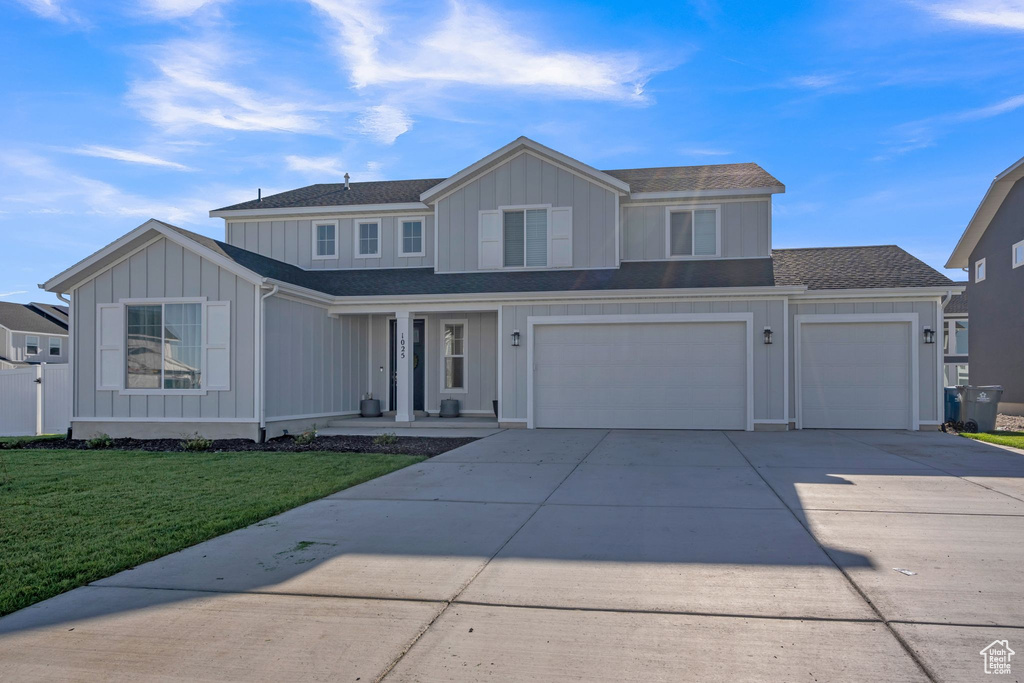 Front of property with a front yard and a garage