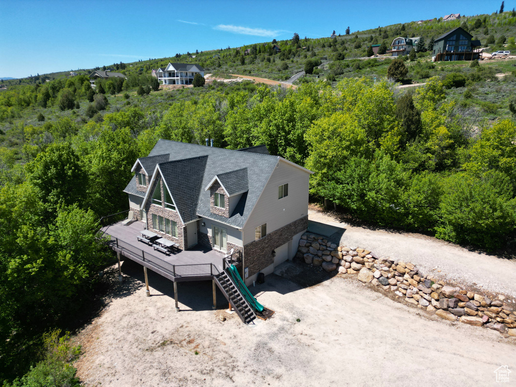 View of subject property with a forest