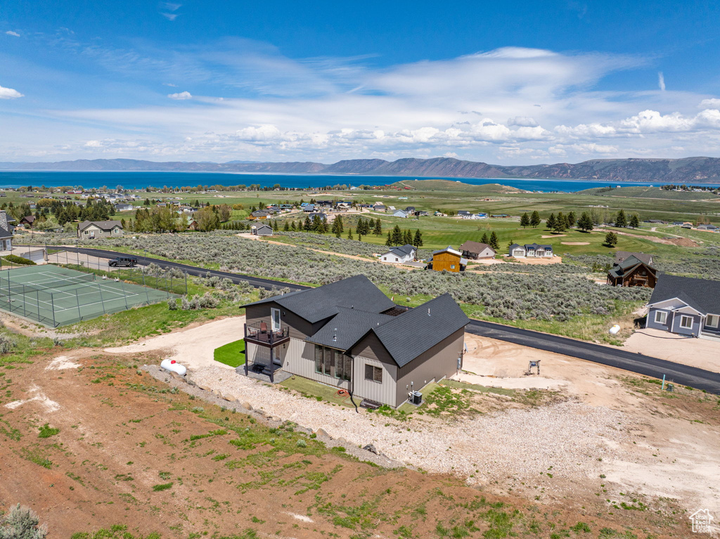 Aerial view of property and surrounding area featuring a mountainous background