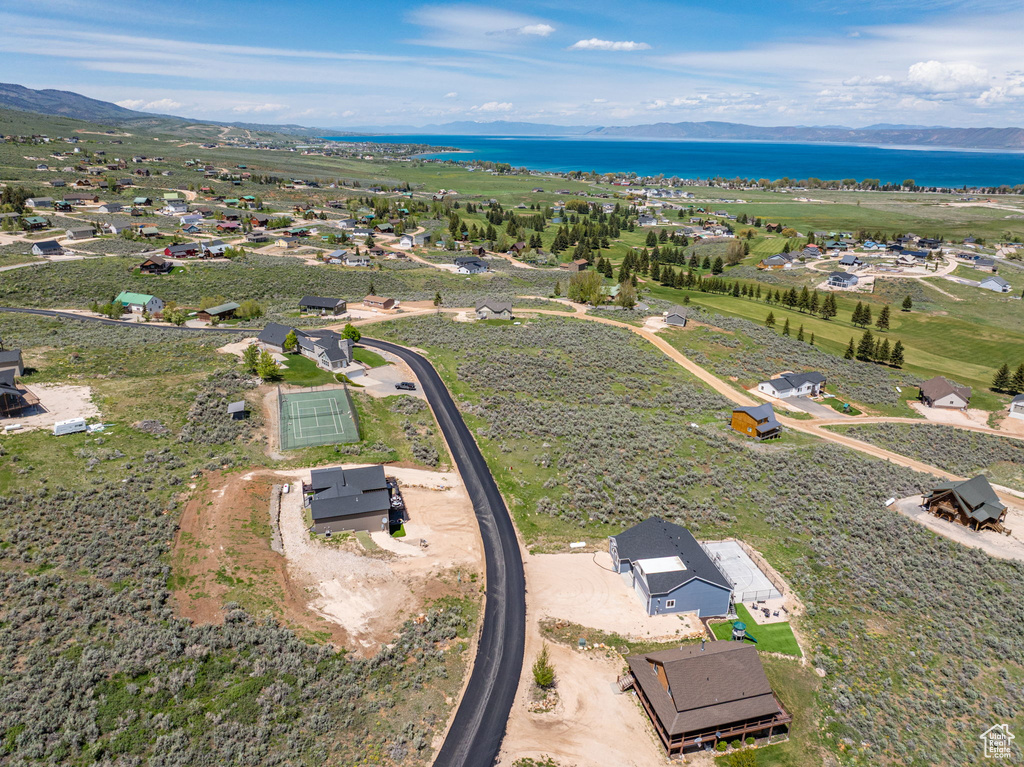 Aerial view of property's location with a water and mountain view
